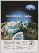 Advertisement features new Horizon Blue casseroles, mixing bowls, and refrigerator-storage sets in various piles atop a planet or asteroid; illuminated moon, planet, or asteroid appears on upper right. Text is featured below. "Corning: cooking in the 70s"